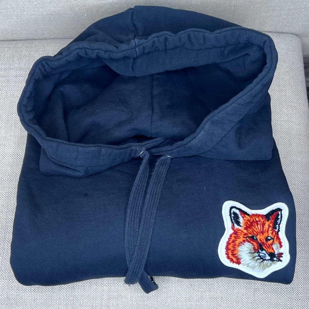 Maison Kitsune black hoodie with brands mascot the fox representing
